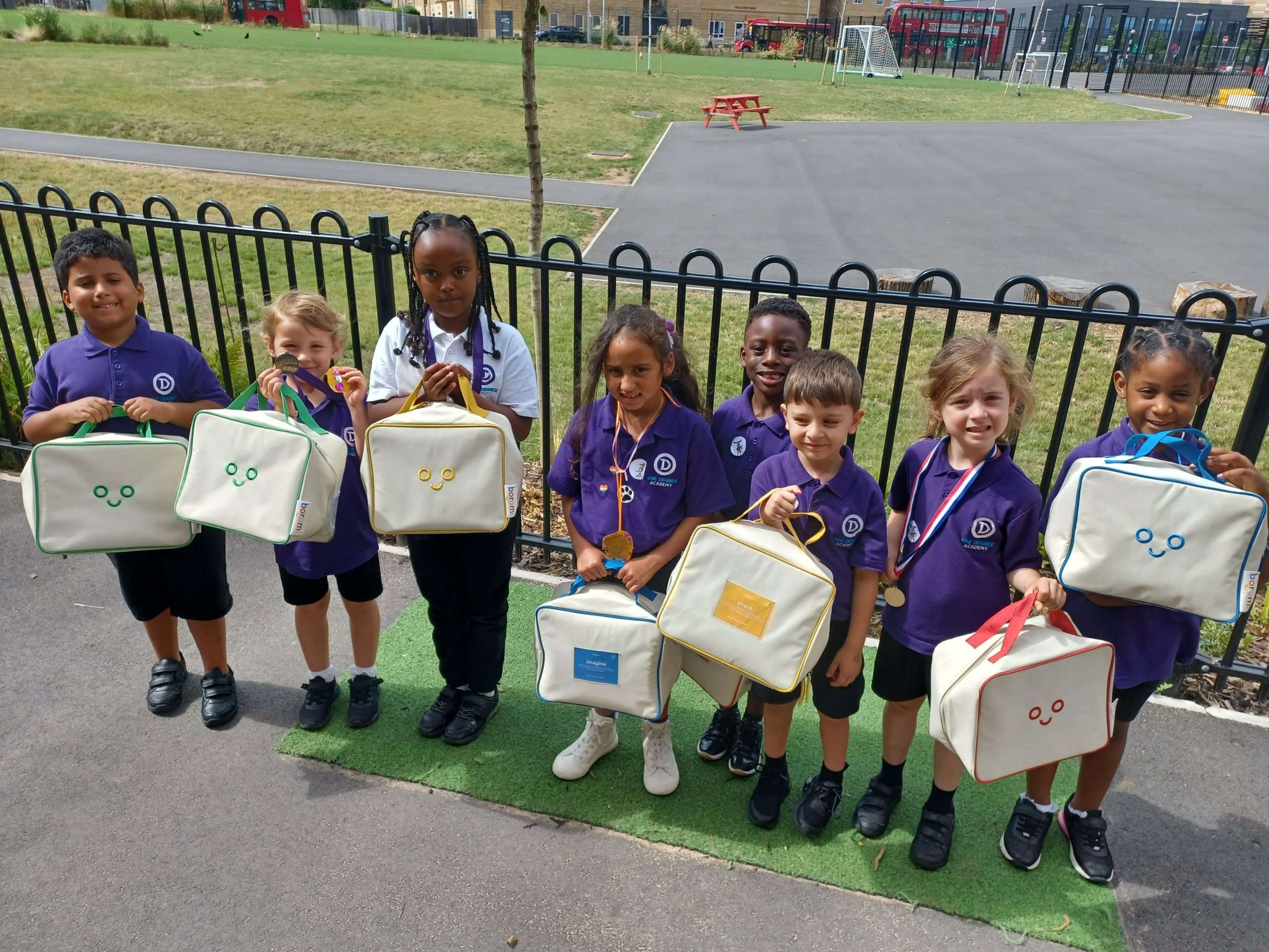 Children at One Degree Academy holding Boromi play bags in the playground