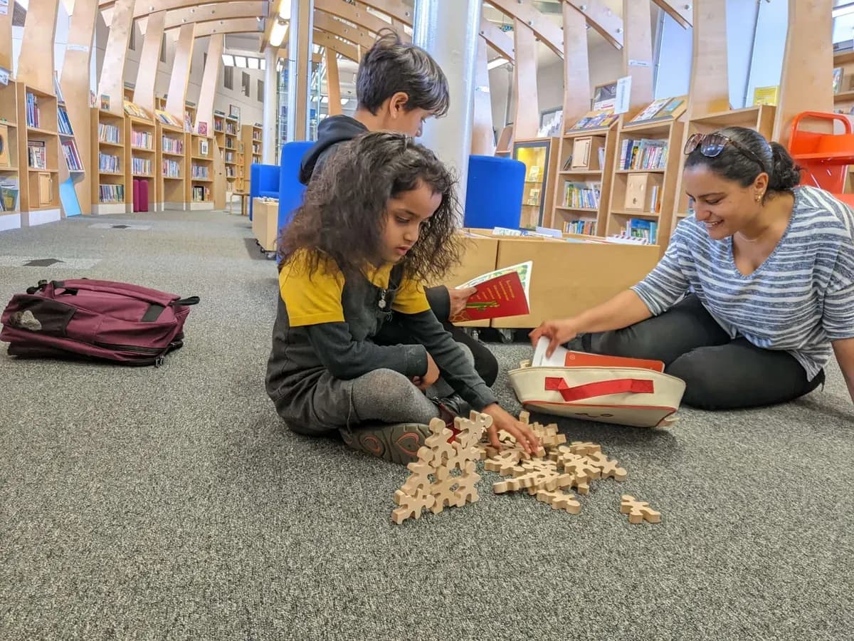 Children playing with wooden blocks at a library
