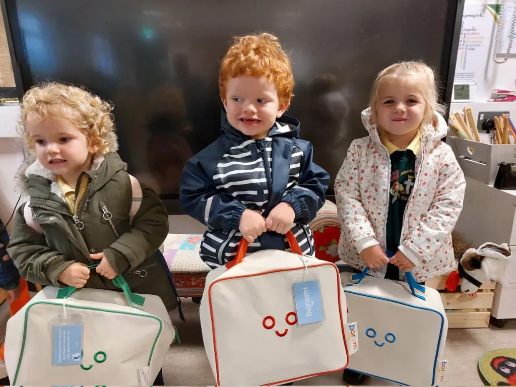 Three young children holding Boromi play bags
