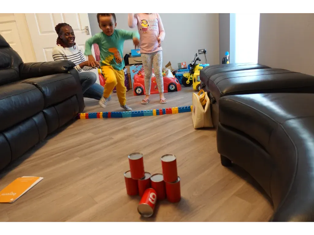 A parent and child playing a stacking game at home