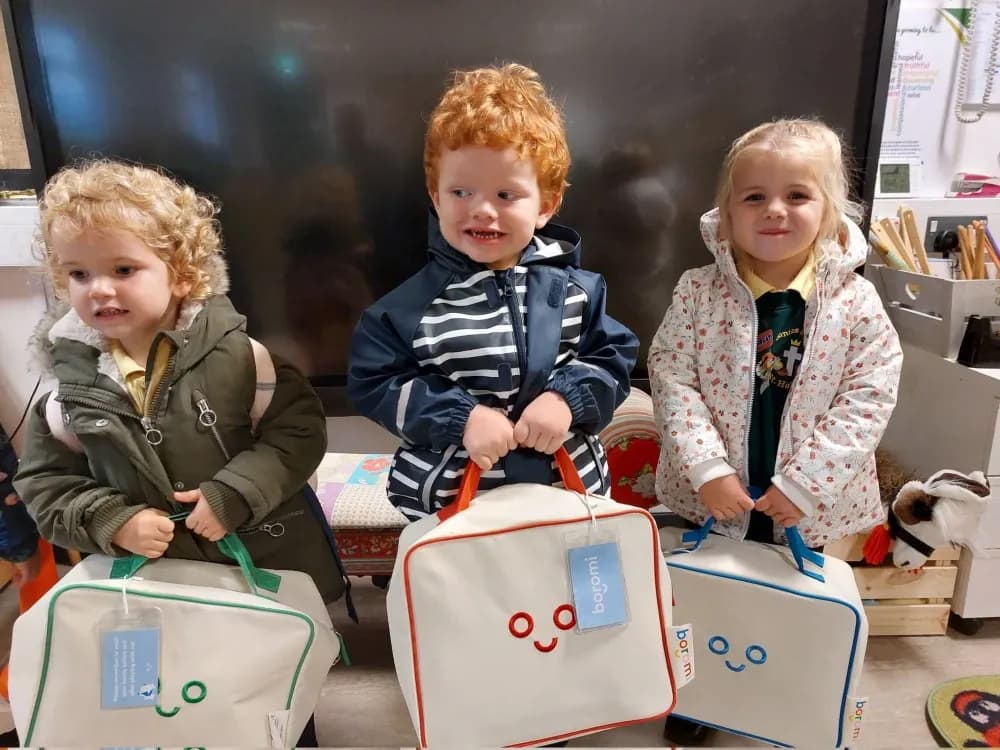 Three young children holding Boromi play bags